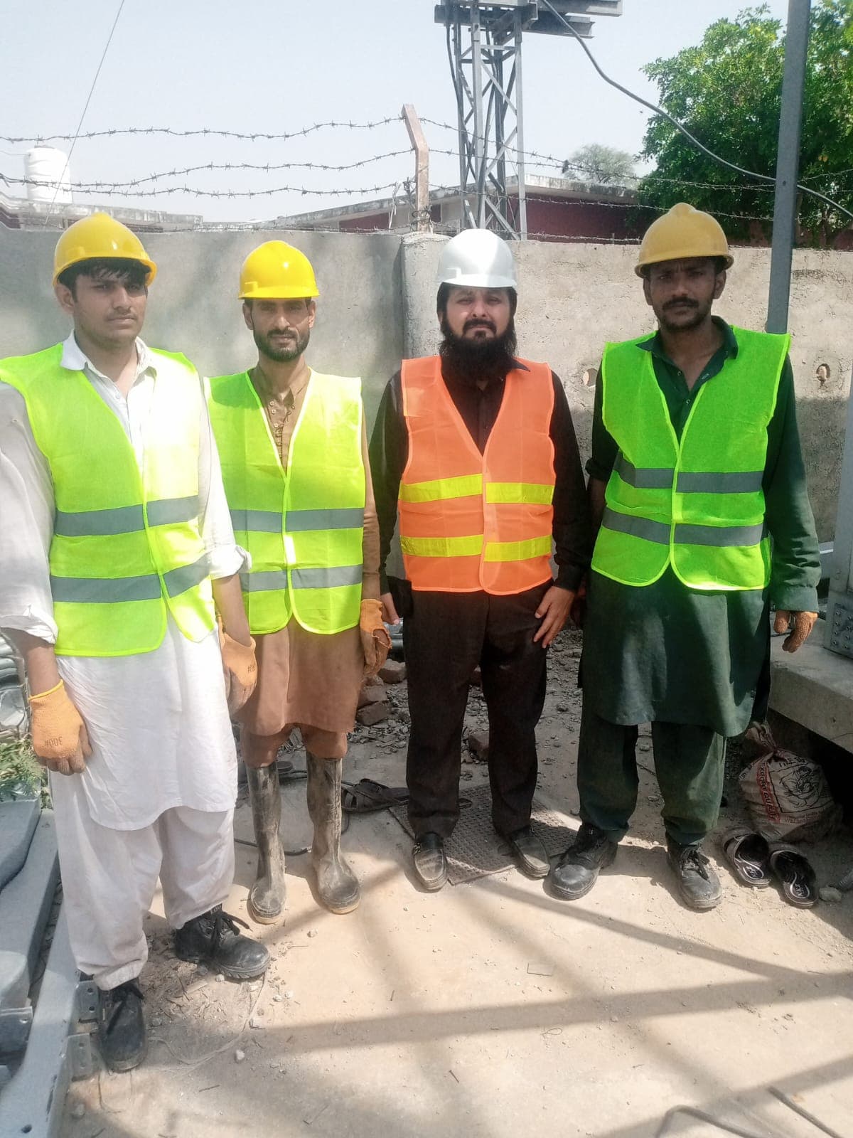 Site team wearing safety helmets and reflective vests