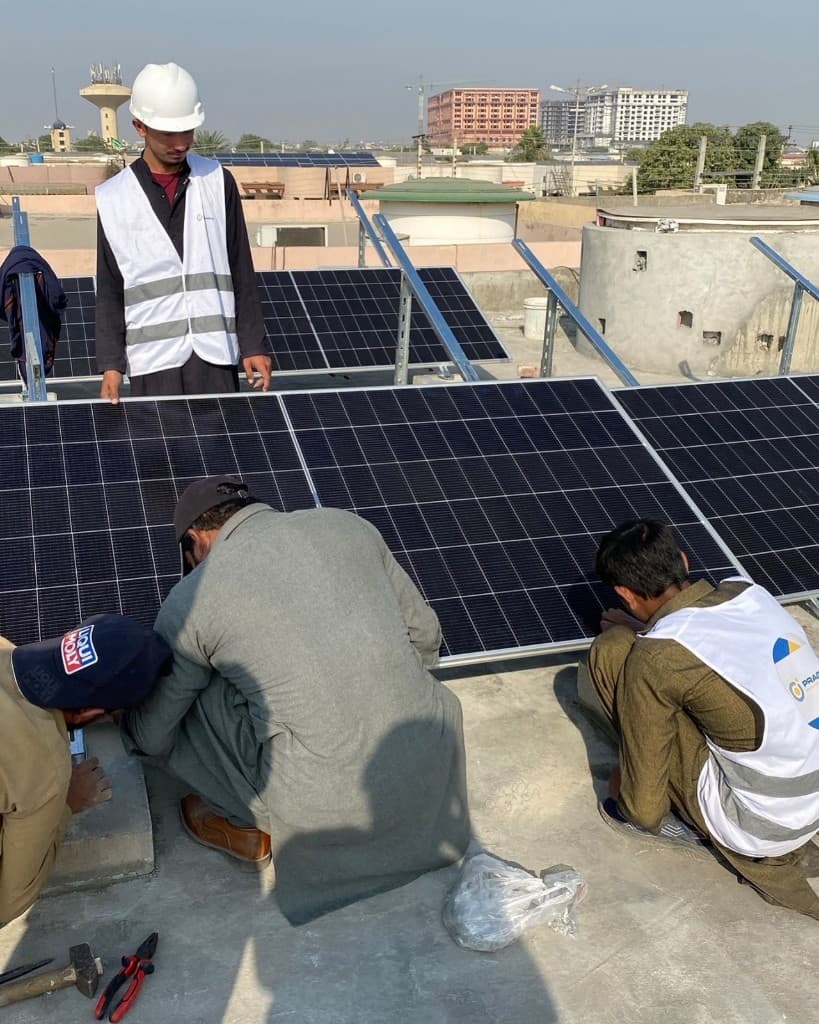 Team installing solar panels